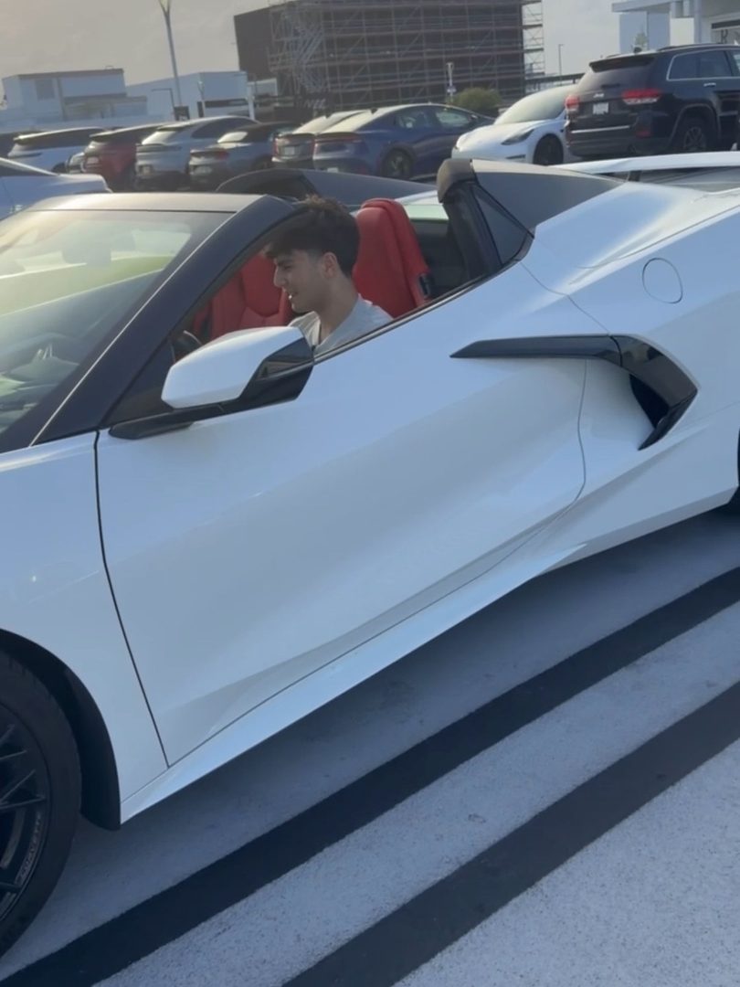 Seyhaun Bozorgi in a Chevrolet Corvette convertible